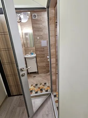 a bathroom with a glass door leading to a shower at Апартамент ИВАНОВИ Сарафово in Burgas City