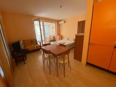 a room with a table and chairs and a bedroom at Stella Polaris 1 Apartments in Sunny Beach