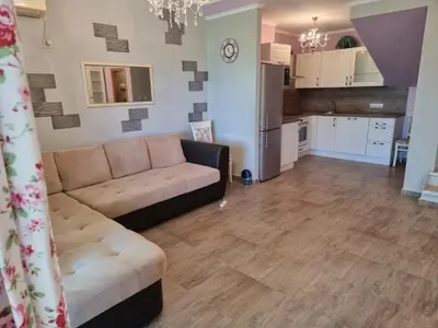 a living room with a couch and a kitchen at Къща на брега на морето Свети Влас, Garden of Eden in Sveti Vlas
