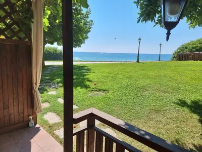 a view of the ocean from the porch of a house at Къща на брега на морето Свети Влас, Garden of Eden in Sveti Vlas