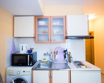 a small kitchen with a sink and a microwave at ALEKS Top Center in Burgas City