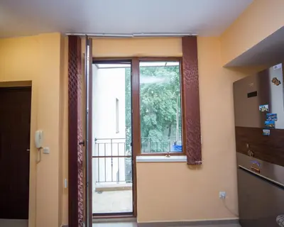 an empty room with a door and a window at ALEKS Top Center in Burgas City