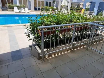 a fence with flowers next to a swimming pool at Sunny Dream Apartments Sunny Beach Bulgarien Sonnenstrand in Sunny Beach