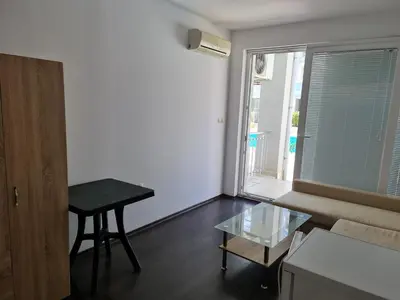 a living room with a table and a window at Sunny Dream Apartments Sunny Beach Bulgarien Sonnenstrand in Sunny Beach