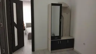 a room with a mirror and a dresser with a television at Valemar Apartments in Pomorie