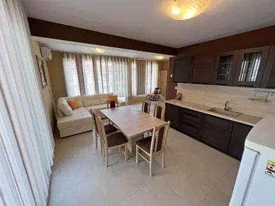 a kitchen with a table and a couch in a room at Valemar Apartments in Pomorie