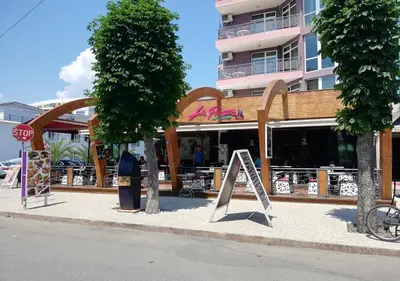 a store with a sign in front of a building at Ideal three bed apartment for families closed to the Beach in Sunny Beach