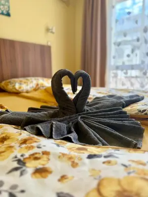 two swans making a heart on a bed at Rooms in New Town Nessebar by Flat Mаnаger in Nesebar