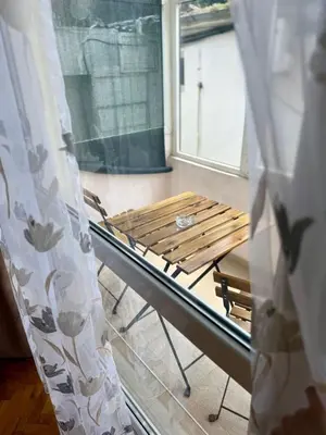 a hospital bed in a room with a window at Rooms in New Town Nessebar by Flat Mаnаger in Nesebar