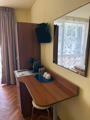 a desk in a room with a mirror on the wall at Rooms in New Town Nessebar by Flat Mаnаger in Nesebar