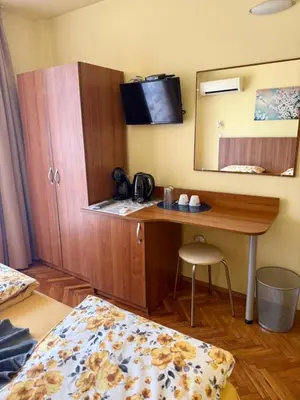 a hotel room with a desk and a mirror at Rooms in New Town Nessebar by Flat Mаnаger in Nesebar