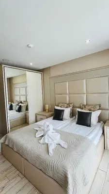 a bedroom with a large bed with a towel on it at PARADISO 'В' 102 PRIVATE SEA VIEW Apartment in Nesebar