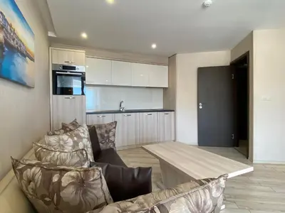 a kitchen and living room with a couch and a table at PARADISO 'В' 102 PRIVATE SEA VIEW Apartment in Nesebar