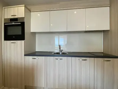 a kitchen with white cabinets and a sink at PARADISO 'В' 102 PRIVATE SEA VIEW Apartment in Nesebar