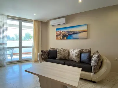 a living room with a couch and a table at PARADISO 'В' 102 PRIVATE SEA VIEW Apartment in Nesebar