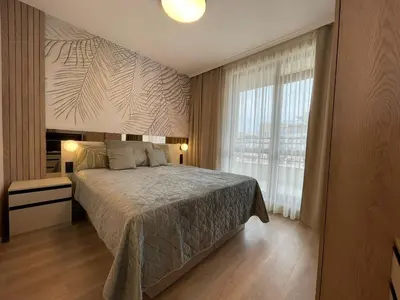 a bedroom with a bed and a large window at Sorrento Sole Mare - Apartments by the beach in Sveti Vlas