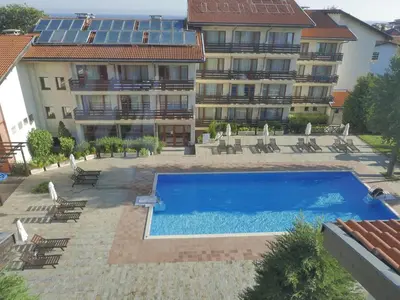 a hotel with a swimming pool in front of a building at Studio Maré Chernomorets in Chernomorets