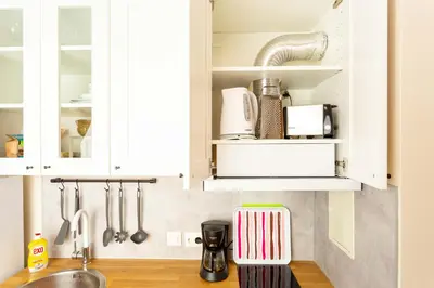 a kitchen with white cabinets and a sink at Studio Maré Chernomorets in Chernomorets