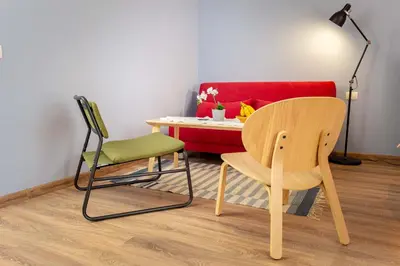 a room with a table and chair and a red couch at Studio Maré Chernomorets in Chernomorets