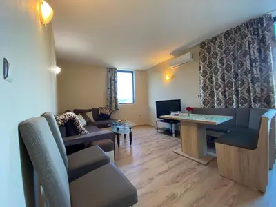 a living room with a couch and a table at AVALON D608 Apartment BIG BAOLCONY Sunny Beach in Sunny Beach