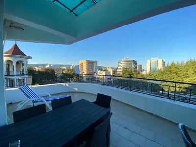 a balcony with a bench and a view of the city at AVALON D608 Apartment BIG BAOLCONY Sunny Beach in Sunny Beach