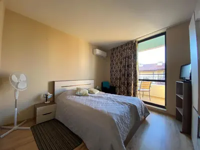 a bedroom with a bed and a large window at AVALON D608 Apartment BIG BAOLCONY Sunny Beach in Sunny Beach