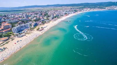 an aerial view of a beach with a boat in the water at AVALON D608 Apartment BIG BAOLCONY Sunny Beach in Sunny Beach