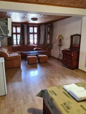 a living room with a couch and a table at Къща за гости Катлея in Tsarevo