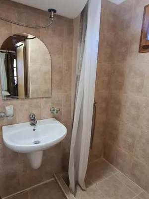 a bathroom with a sink and a shower at Къща за гости Катлея in Tsarevo