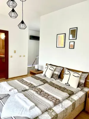a bedroom with a large bed with pillows at Penthouse Panorama Sea View Apt. Pomorie in Pomorie