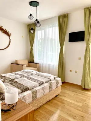 a bedroom with a bed and a large window at Penthouse Panorama Sea View Apt. Pomorie in Pomorie
