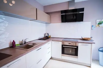 a white kitchen with a sink and a stove at Black Sea Top Centre Apartments by Flat manаger in Varna City