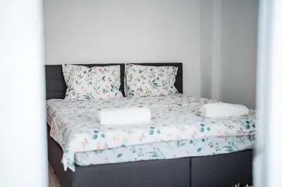a bed with two pillows on top of it at Black Sea Top Centre Apartments by Flat manаger in Varna City
