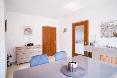 a living room with a table and blue chairs at Black Sea Top Centre Apartments by Flat manаger in Varna City