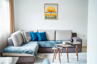 a living room with a couch and a table at Black Sea Top Centre Apartments by Flat manаger in Varna City