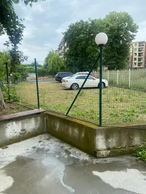a fence with a gate and a car in a parking lot at Dadi Oazis Ravda in Ravda