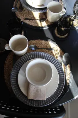 a black table with plates and cups and utensils at A&K Guest Studio in Varna City