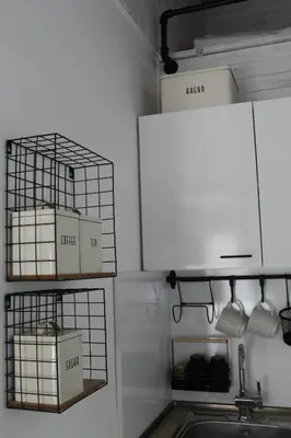 a kitchen with a sink and boxes on the wall at A&K Guest Studio in Varna City