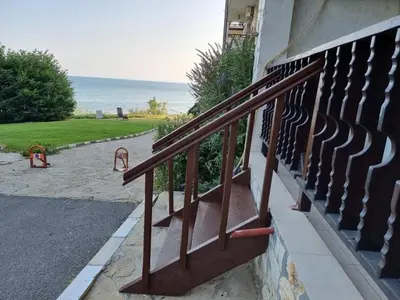 a metal railing on a staircase with a view of the ocean at Апартамент с фронтална гледка море in Sveti Vlas