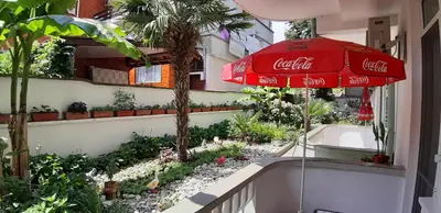 a cocacola umbrella sitting on the side of a building at Laguna in Kiten