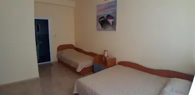 a hotel room with two beds and a mirror at Laguna in Kiten