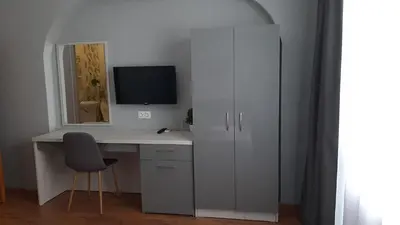 a white computer desk with a monitor and a chair at Laguna in Kiten