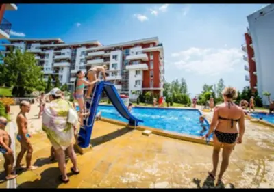 a group of people playing in a swimming pool at 2-комнатные апартаменты у моря 10 бассейнов Crown Fort Noks in Sveti Vlas