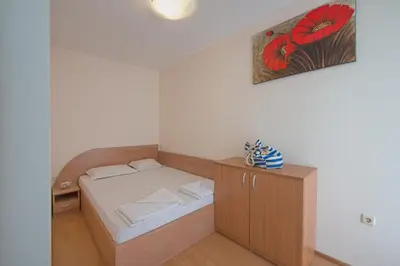 a small room with a bed and a cabinet at Chateau Del Mar Holiday Apartments in Sunny Beach