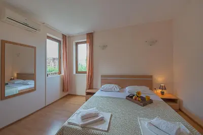 a bedroom with a large bed and a mirror at Chateau Del Mar Holiday Apartments in Sunny Beach