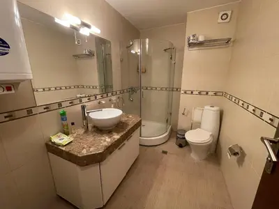 a bathroom with a sink and a shower and a toilet at Luxury apartment whit sea view at Sunny Beach in Sunny Beach
