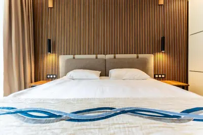 a bedroom with a bed with a blue ribbon on it at Galeon Residence & SPA in Sunny Beach