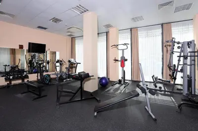 a gym with several treadmills and exercise bikes at Galeon Residence & SPA in Sunny Beach