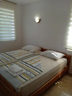 two beds sitting next to each other in a bedroom at Guest House DARIS-APHRODEYA Къща за Гости ДАРИС-АФРОДЕЯ in Sozopol