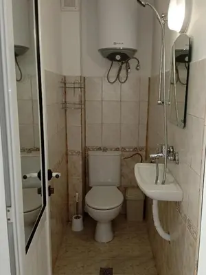 a small bathroom with a toilet and a sink at Guest House DARIS-APHRODEYA Къща за Гости ДАРИС-АФРОДЕЯ in Sozopol